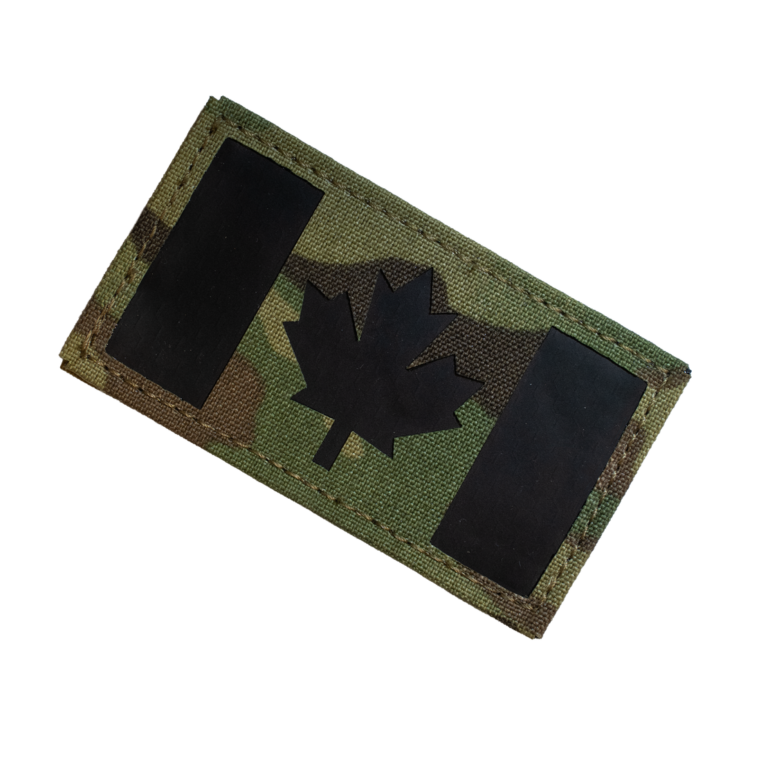 Camouflage patch with a black maple leaf on a white background