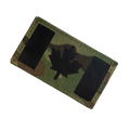 Camouflage patch with a black maple leaf on a white background