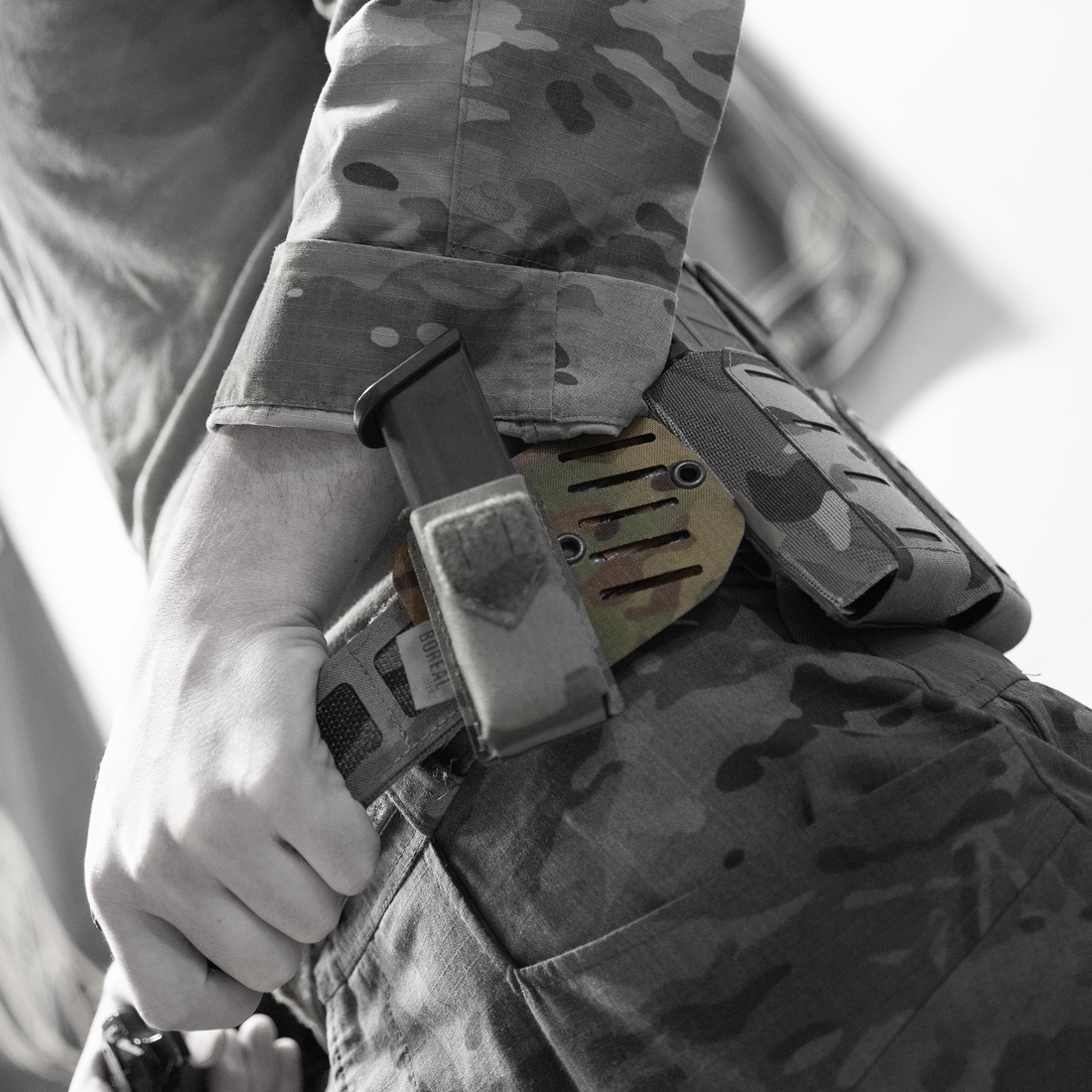 A camouflage-patterned C30 adaptor kit attached to a belt