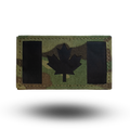 Multicam patterned patch with black maple leaf design on a white background
