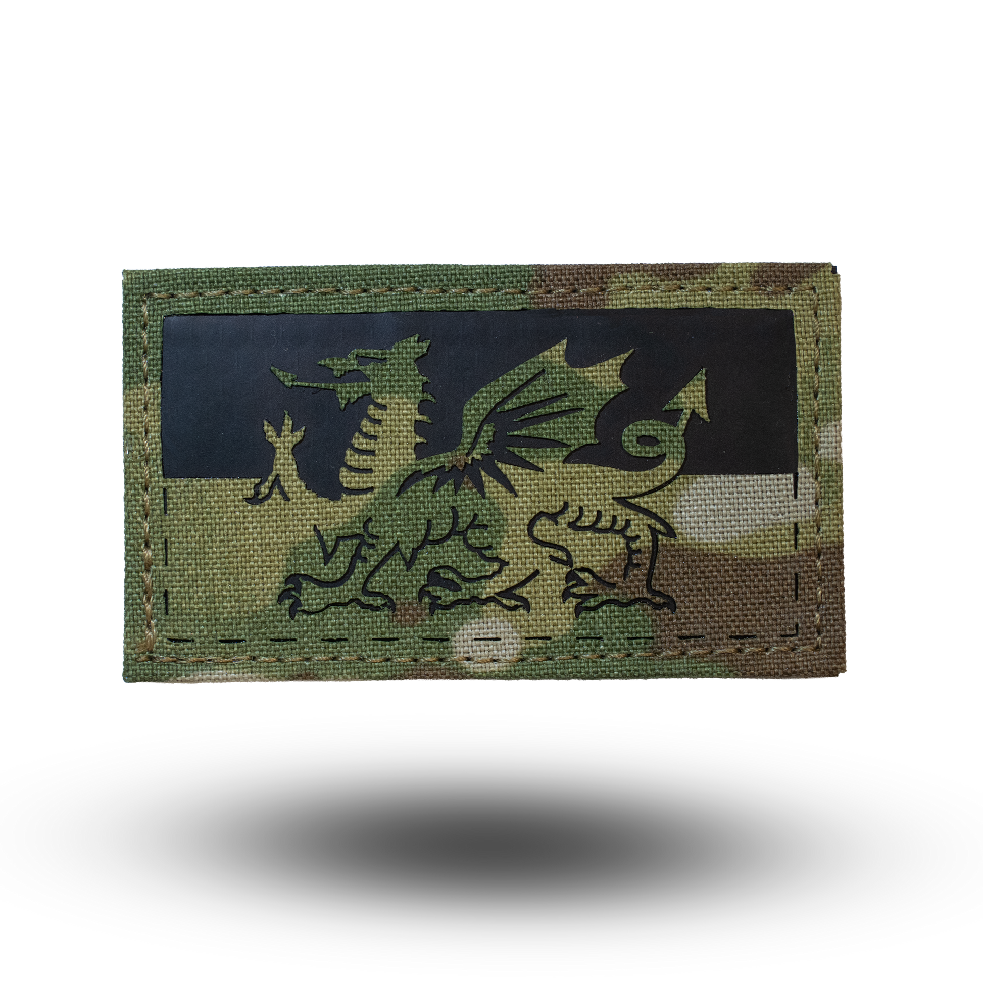 Multicam patch with a dragon design on a white background